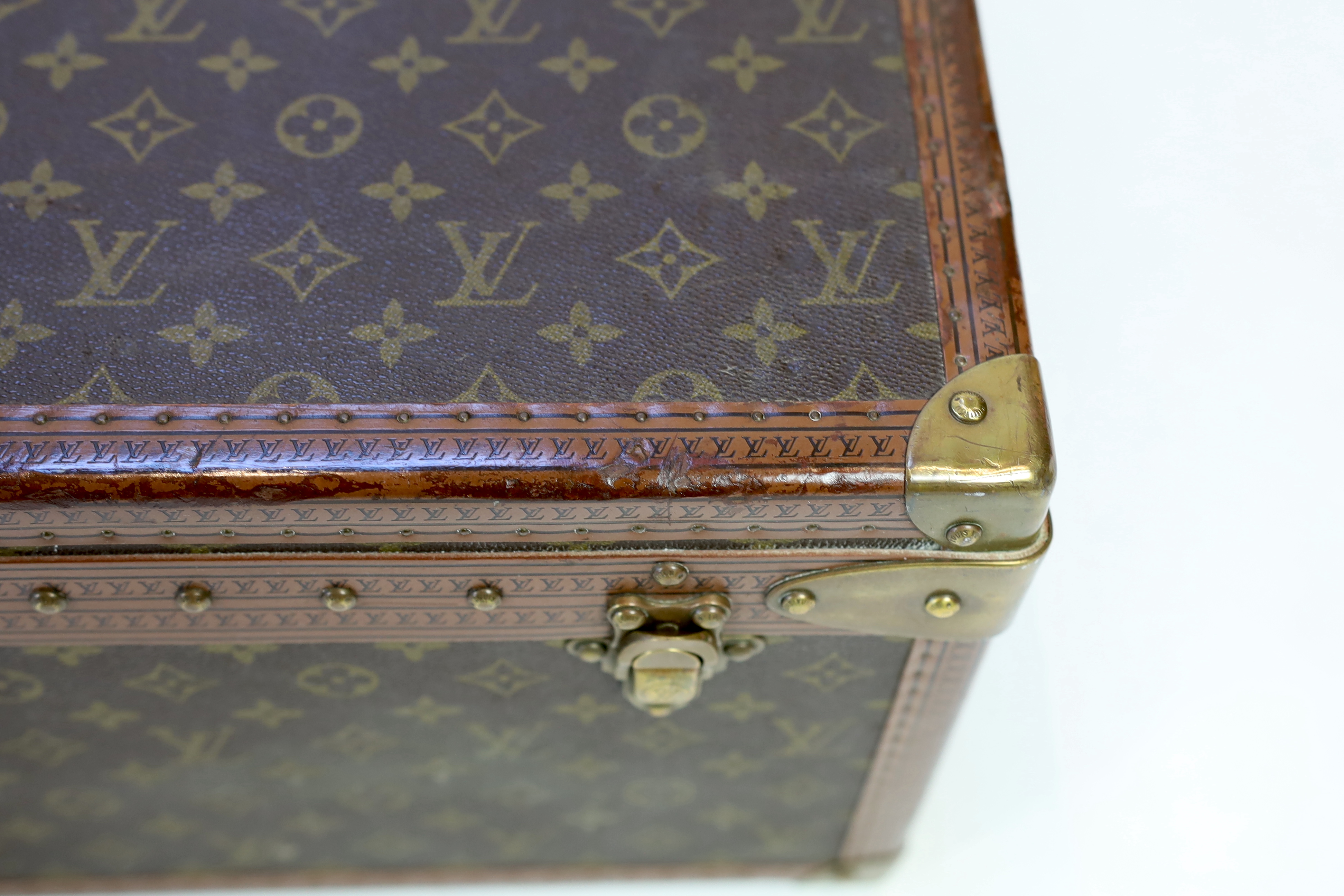 A Louis Vuitton monogram canvas and tan leather suitcase, width 81cm, depth 26cm, height 52cm